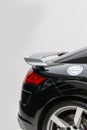 Vertical side view of the black Audi TT RS rear wing before a white background