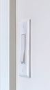 Vertical Side view of electrical rocker light switch mounted on white interior wall