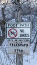 Vertical Signages by a foot path trail at Wasatch Mountains blanketed with snow in winter