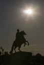 Vertical silhouette of Bronze Horseman sculpture of Peter the Great on blue sky and sunshine background