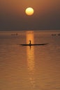 Vertical silhouette of canoes on Niger River