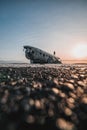 Vertical silhouette of a person standing on solheimasandur plane wreck in Iceland against the sky