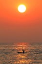 Vertical silhouette of a solo kayaker during sunset on Lake Huron, United States