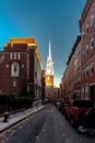 Vertical skyline of Boston downtown buildings along a road with parked cars, the Old North Church Royalty Free Stock Photo
