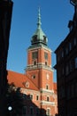 Vertical of the skyline of the red Royal Castle clock tower against the blue sky in Warsaw, Poland Royalty Free Stock Photo