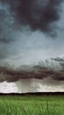 Vertical, slider shot, 4K time-lapse, timelapse. Dramatic Sky With Rain Clouds On Horizon Above Rural Landscape Field
