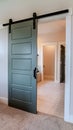 Vertical Sliding gray wooden panel door that leads to the bathroom of a home Royalty Free Stock Photo