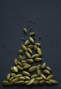 Vertical small DOF close up photo of Cardamom pods and seeds pile on the matt black background. It is very popular in Indian and Royalty Free Stock Photo