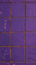 Vertical small purple weathered and damaged tiles wall background texture