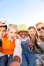 Vertical Smiling selfie of a happy group of multicultural friends looking at the camera. Portrait of cheerful Royalty Free Stock Photo