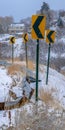 Vertical Snowy road with directional road signs in winter Royalty Free Stock Photo