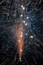 vertical of sparkler shooting firework sparks at night