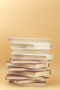 vertical stack of books on an orange background Royalty Free Stock Photo