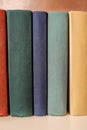 Vertical stack of old books on a shelf