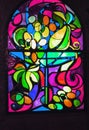 Vertical stained glass window with abstract background of multicolored glass with plant and fruit ornaments