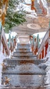 Vertical Stairway going down to a road on a hill with fresh white snow in winter Royalty Free Stock Photo