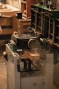 Vertical steel knife cutting blade machine, grinder throwing wood chips, sawdust in carpenter office, garage, workshop