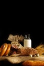 Vertical still life on a table with milk, bread and eggs in warm colors, copy space for your text Royalty Free Stock Photo