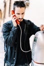 Vertical photo of a boy calling through a phone booth Royalty Free Stock Photo