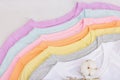 Vertical storage of clothing. Eco spring closet cleaning. Pastel baby T-shirts, sale concept Royalty Free Stock Photo