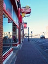 Vertical street view of the retro style neon sign of coca cola in the city of Williams, Arizona