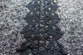 Vertical stripe of black lace on grey melange woolen fabric Royalty Free Stock Photo