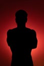 Silhouette of a young man with crossed arms Royalty Free Stock Photo