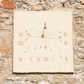 Vertical sundial made of carved stone's slab and iron rod