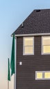 Vertical Sunlight reflecting on the windows of a house