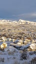 Vertical Sunset in scenic Utah Valley with homes and mountain covered with winter snow Royalty Free Stock Photo