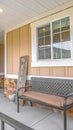 Vertical tall frame Bench and stool in front of a window at the porch of a home