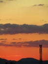 Vertical of telecom tower's silhouette captured against an orange sky at sunset Royalty Free Stock Photo