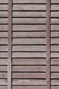 Vertical texture of a wall from several rows of brown old wooden boards. Painted wooden wall in brown colo Royalty Free Stock Photo