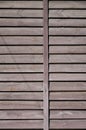 Vertical texture of a wall from several rows of brown old wooden boards. Painted wooden wall in brown colo Royalty Free Stock Photo