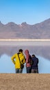 Vertical Three tourists in Bonneville Salt Flats, Utah, USA