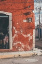 Vertical of a timeless, eroded red-walled street corner in the streets of Valladolid, Mexico. Royalty Free Stock Photo