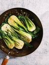 Vertical top view of Bok choy on a fryng pan Royalty Free Stock Photo