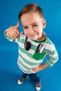 Vertical top view image of young boy posing with headphone Royalty Free Stock Photo