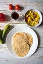 Vertical top view of popular Indian breakfast puri and sabzi