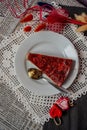 Vertical top view of a slice of strawberry and chocolate cheesecake on the white plate with a spoon Royalty Free Stock Photo