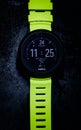 Vertical top view of Suunto D5 dive watch with a black screen and neon green straps