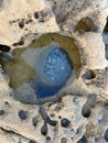 Vertical tope view of a cliff with transparent water in its craters