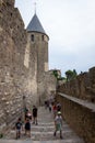 Vertical of tourists walking in the Carcassonne medieval citadel in the south of France