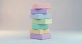 A balanced stack of seven soft pastel colored blocks against a neutral background Royalty Free Stock Photo