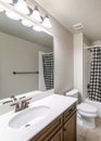 Vertical Traditional bathroom interior with checkered black and white shower curtain Royalty Free Stock Photo