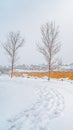 Vertical Trail on the powdery snow along Oquirrh Lake with view of homes and vast sky