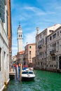 Water canal with view of leaning bell tower in the city center of Venice, Italy. Royalty Free Stock Photo