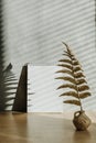Vertical trend mockup with shadows and golden leaves. Fall autumn minimal mock up with open empty note pad, golden fern leaves and