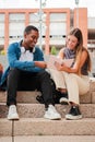 Vertical. Two multiracial teenage studens learning together at university campus. African american schoolboy talking