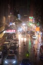 Vertical urban shot of a traffic in Sai Yeung Choi street on a rainy night in Mong Kok, Hong Kong Royalty Free Stock Photo